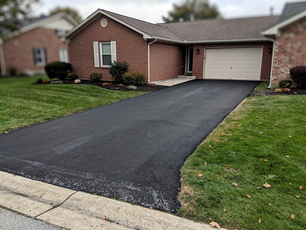 Newly paved asphalt driveway at a McLean, VA brick home