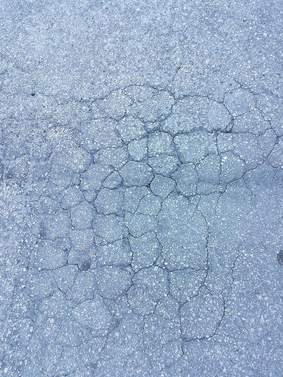 Close-up of cracked, alligatored asphalt that has lost its binder